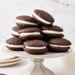 Classic whoopie pies with soft chocolate cakes and fluffy marshmallow filling stacked on a plate
