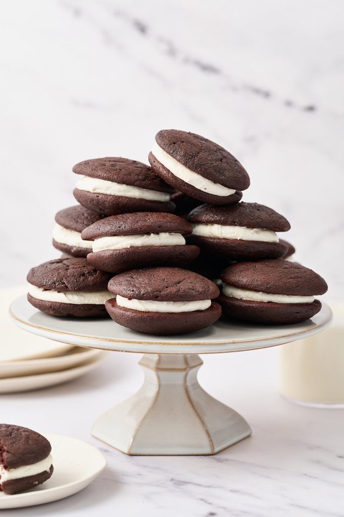 Classic whoopie pies with soft chocolate cakes and fluffy marshmallow filling stacked on a plate